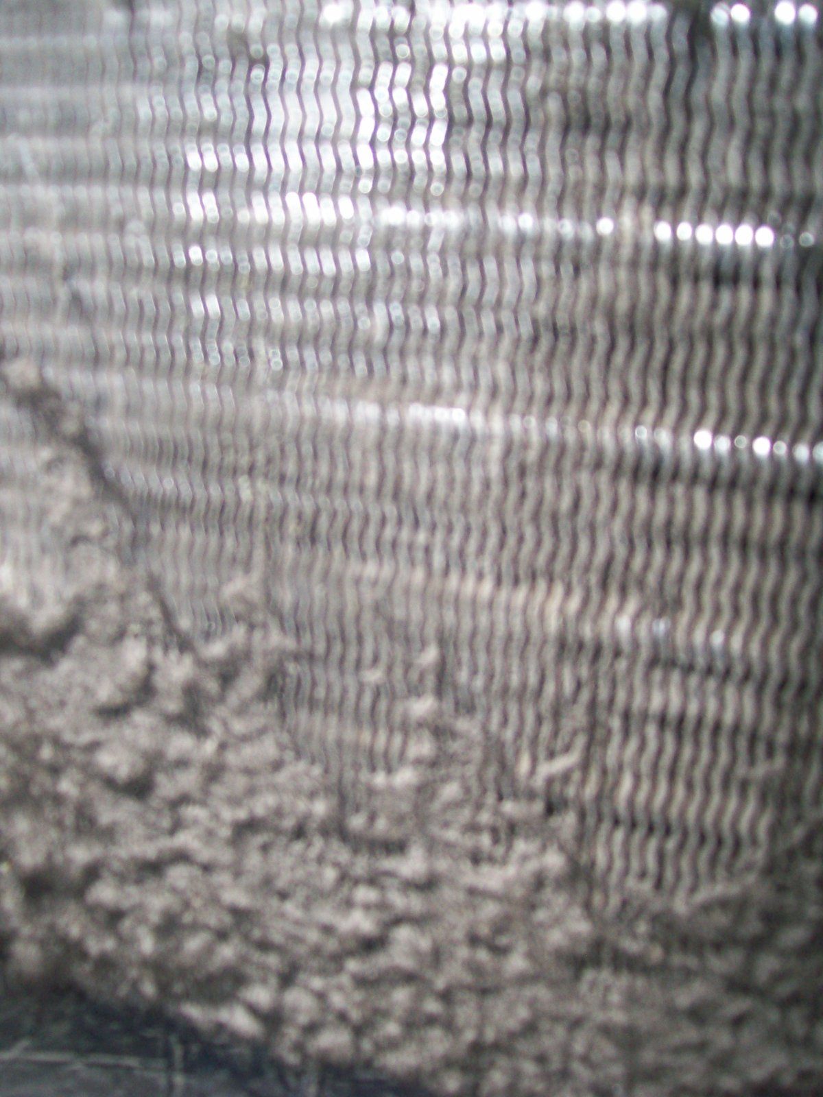 Neglected, dirty HVAC coil fins fouled with grime