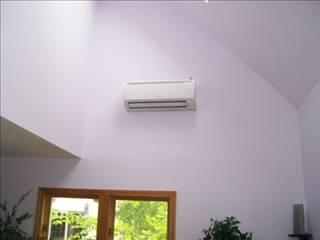 Mitsubishi indoor wall-mount ductless head unit installed in a room